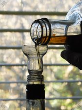 [Orange liqueur pouring through
 home-made funnel]